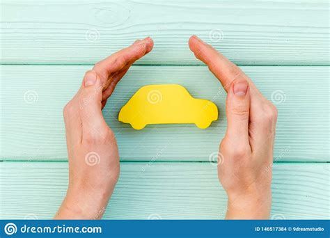 Car Buying And Insurance Concept With Car Figure In Hands On Mint Green